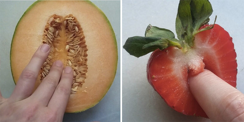 Woman sticking her finger in fruit