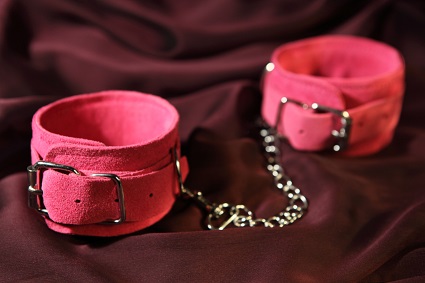 A pair of pink handcuffs