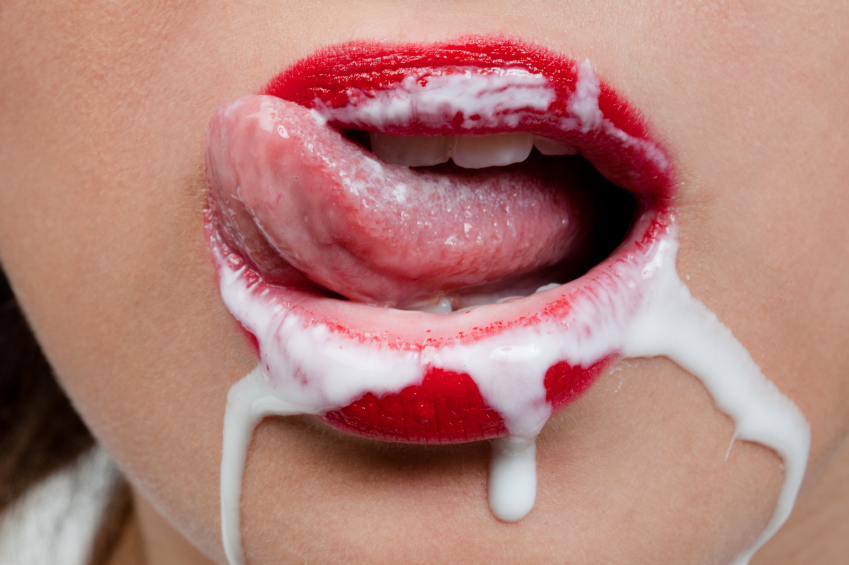 Woman licks cream from her mouth