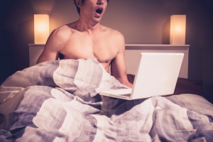 Man in bed with laptop