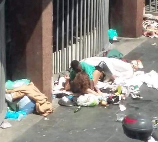 Couple having sex on rubbish dump